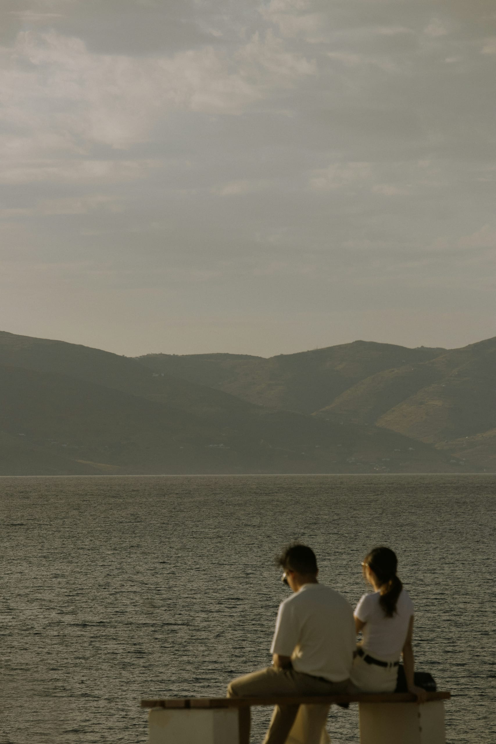 A couple looking out over the water at golden hour