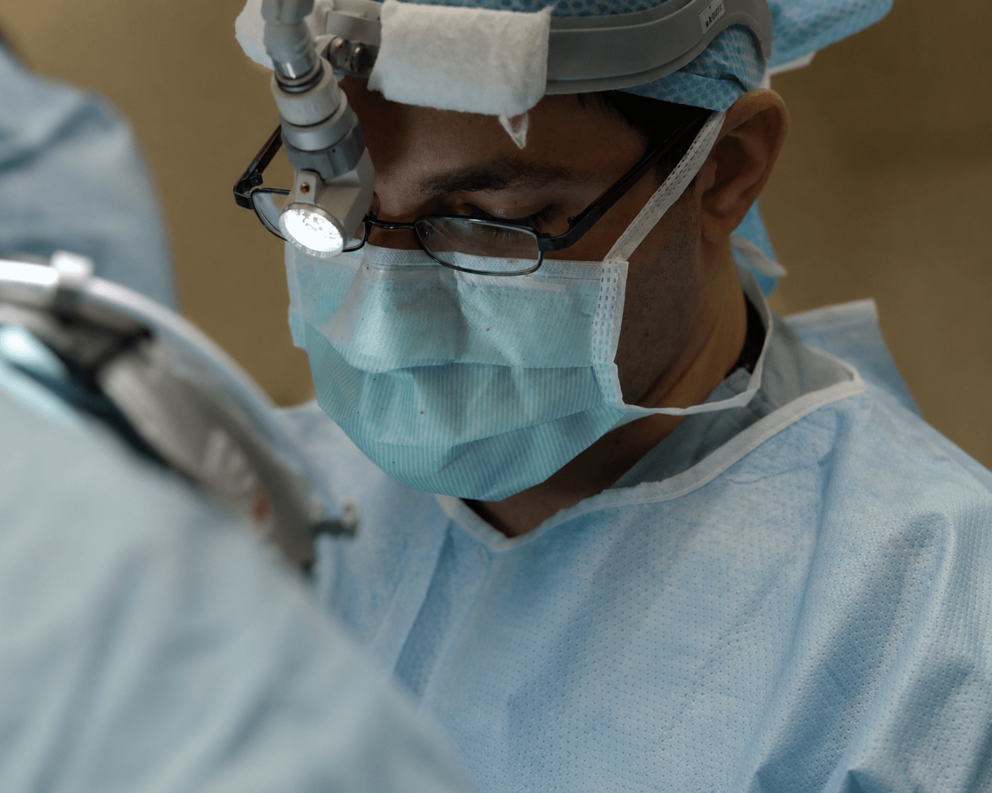 A surgeon focused mid-procedure
