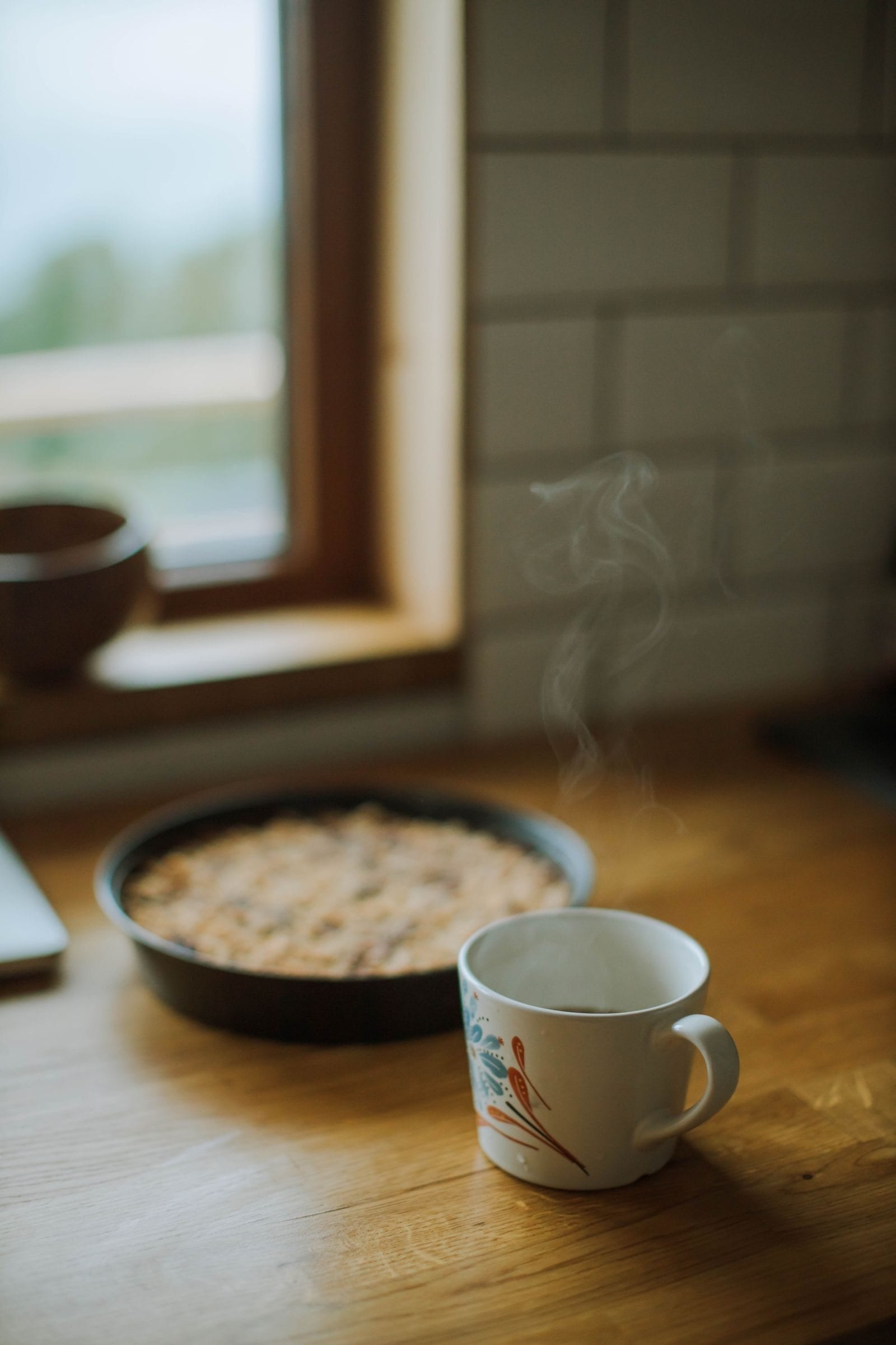 Morning coffee on a wooden table beside a window