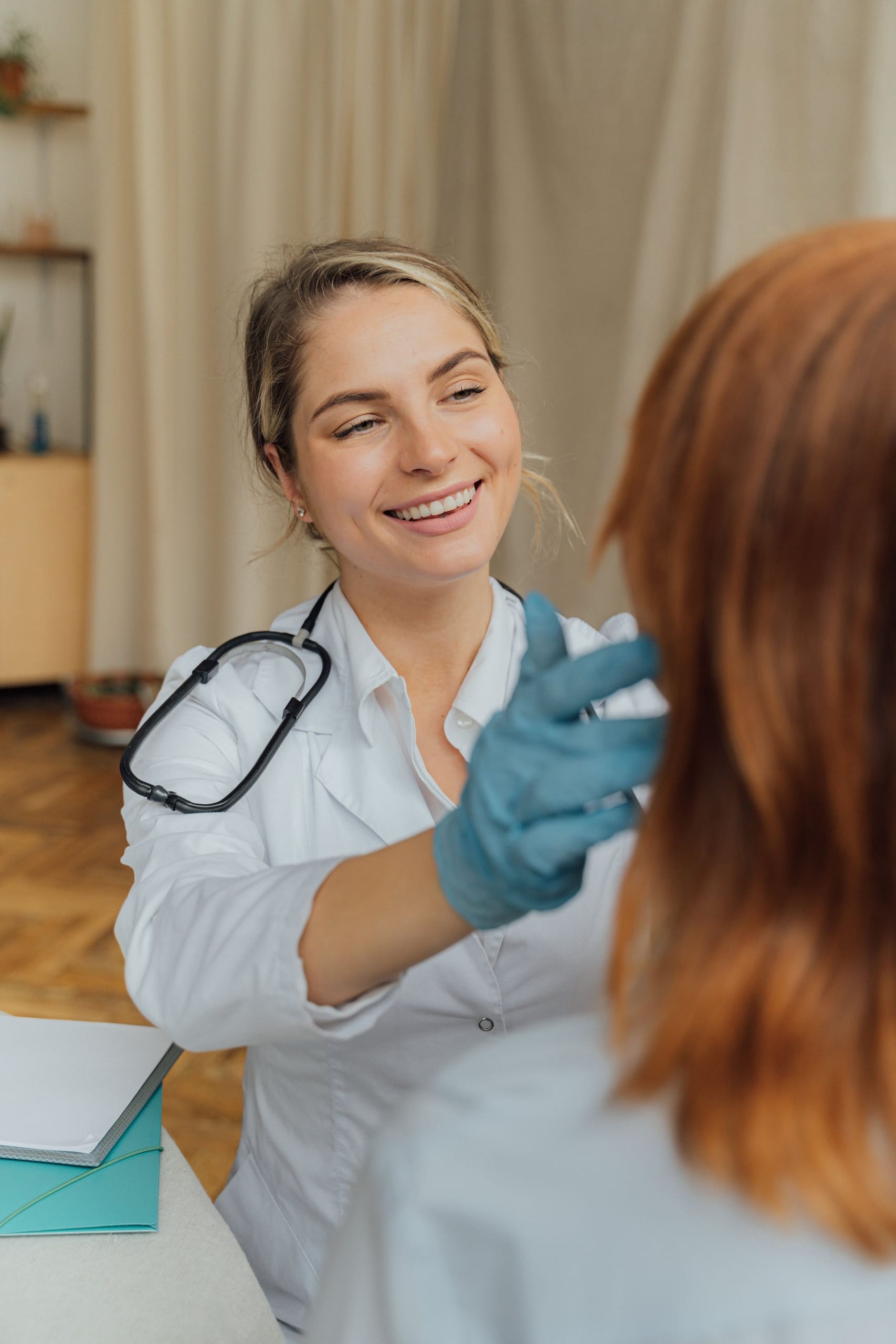 A smiling physician in a white coat with a patient