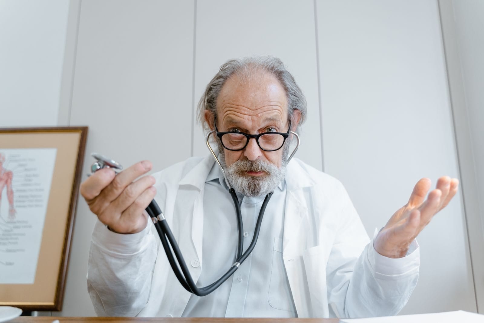 A senior physician talking in his office