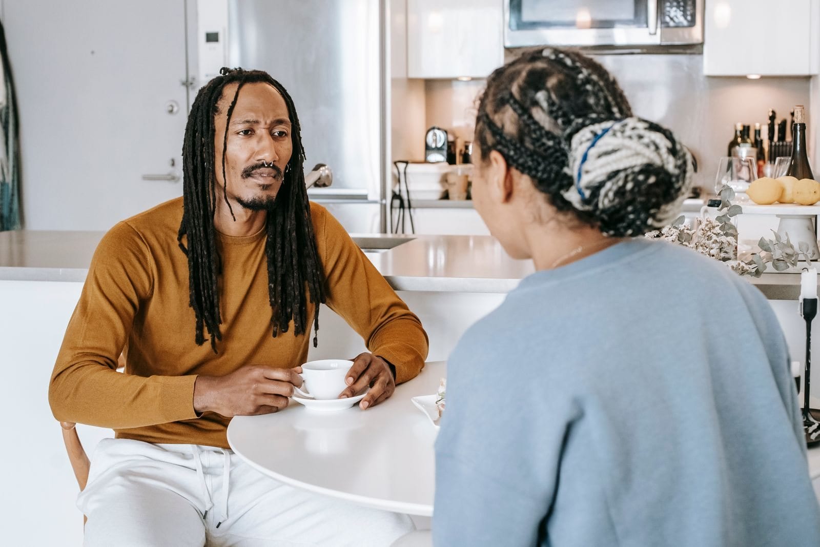 Two people talking warmly over coffee