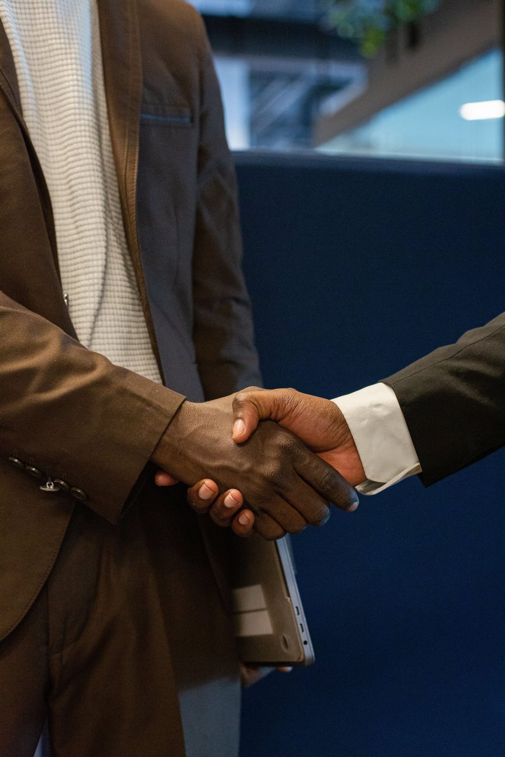 Two people shaking hands in an office