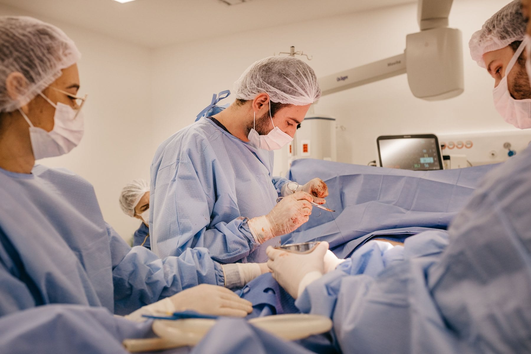A surgical team at work in a bright operating room
